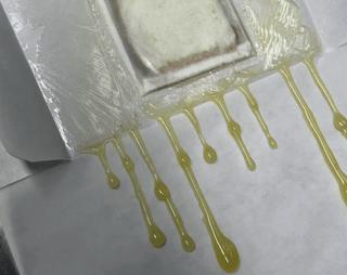 Jelly Raunchers rosin bag press showing wet resin drip